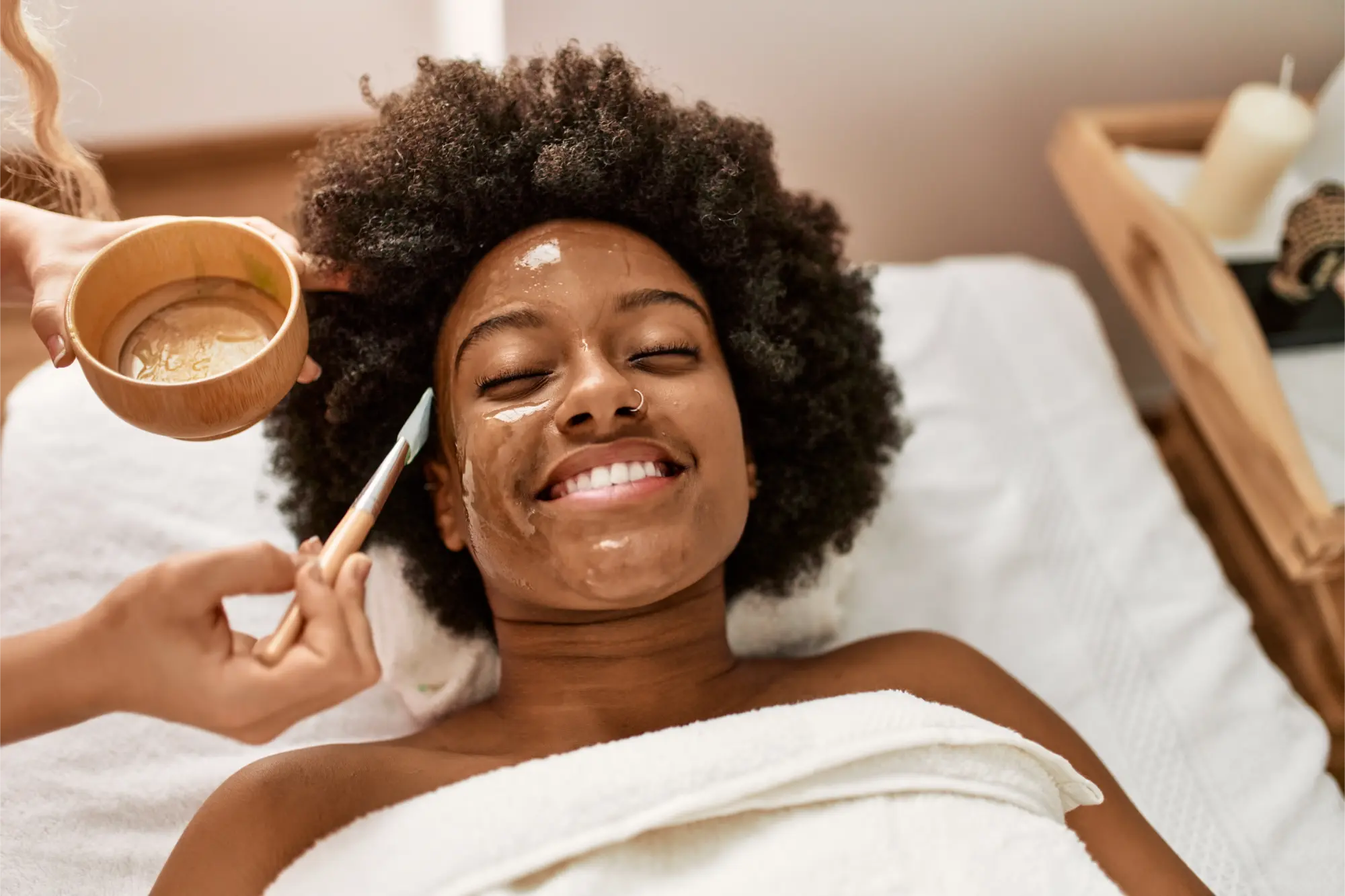 “Woman receiving a facial treatment with gentle care, relaxing with eyes closed.”
