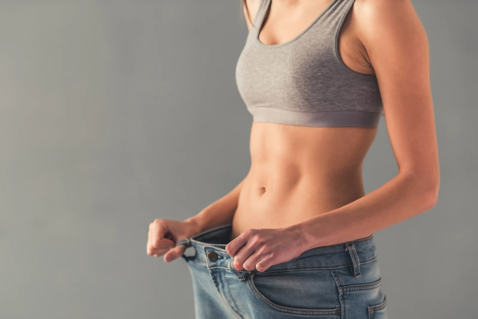 “Graphic showing weight loss concept with measuring tape around a person’s waist.”
