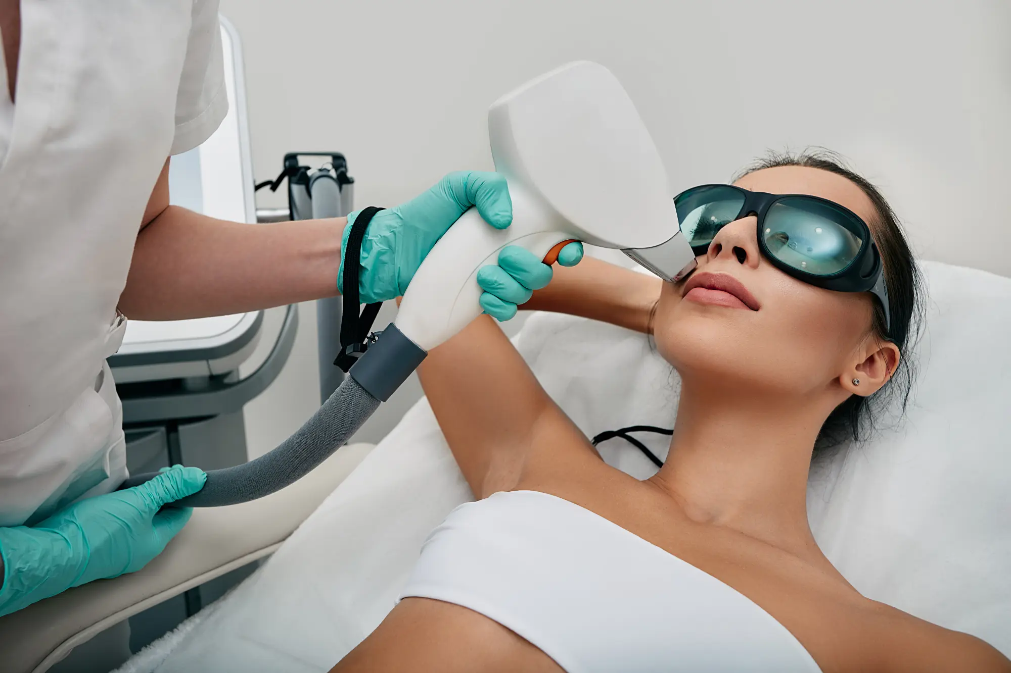 “Person receiving laser hair removal treatment on the leg, illustrating the laser hair‑free smooth skin procedure.”