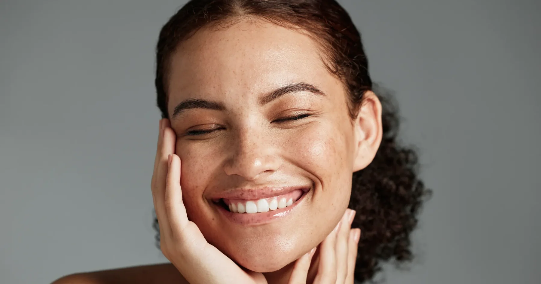 “Smiling person’s face representing Gentle Giant Care aesthetic and wellness services.”